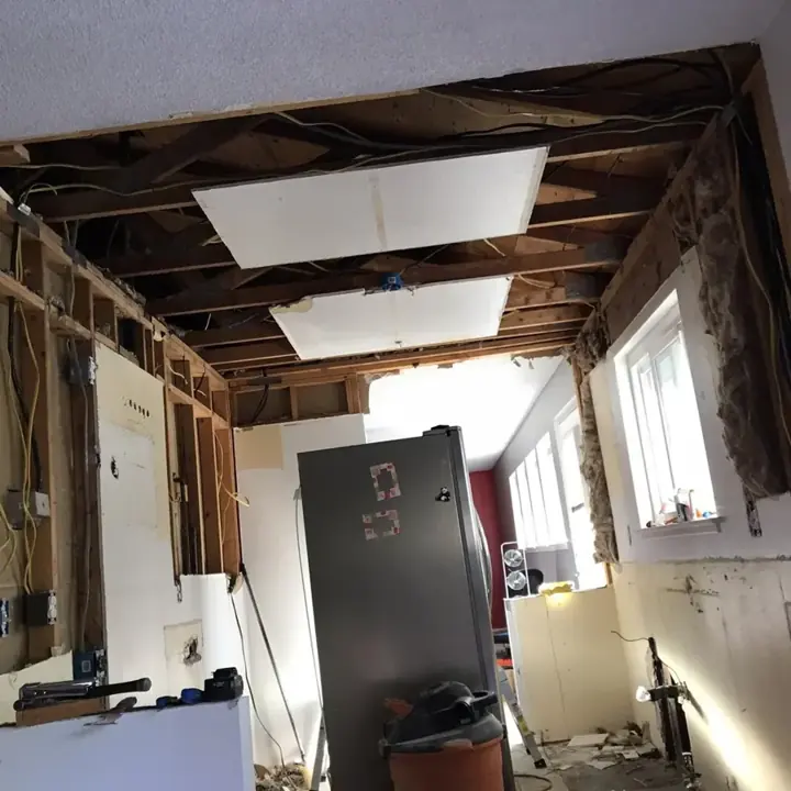 Kitchen ceiling and walls opened to dry the framing in a Brighton home