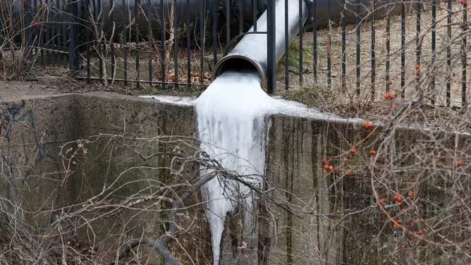Frozen downspout outlet encased in ice during a Brighton winter